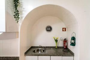 eine Küche mit einer Spüle und einem Torbogen in der Unterkunft One bedroom apartement with wifi at Porto 3 km away from the beach in Porto