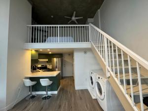a duplex apartment with a staircase and a laundry room at LUXURY LOFT IN DOWNTOWN VANCOUVER in Vancouver