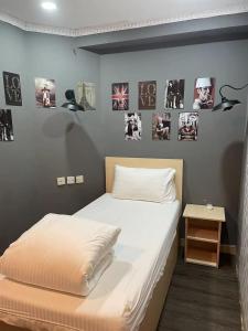 a bedroom with two beds and pictures on the wall at The House (Baguio) in Hong Kong