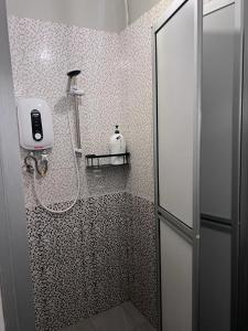 a shower with a glass door in a bathroom at Sunshine House in George Town