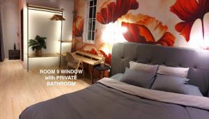a bedroom with a bed with a large flower mural on the wall at Nhà Yên 1 Bed 2 Beds Hotel Homestay Hostel Cần Thơ in Can Tho