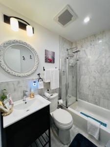 a bathroom with a toilet and a sink and a shower at Eleni’s Charming Studio in North Beach