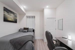 a white bedroom with a bed and a desk and a desk at Luxurious & Spacious 3Bed/3Bath with Outdoor Patio in Philadelphia