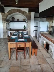 a kitchen with a table with plates on it at La petite maison de Chavroches - proche du Pal 