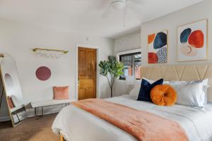 a bedroom with a bed with an orange pillow on it at Contemporary loft 5-min to downtown in Pittsburgh