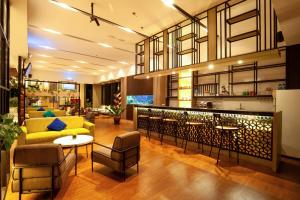 a living room with a yellow couch and chairs at Amani Suite and Apartment ZN41 in Senggigi