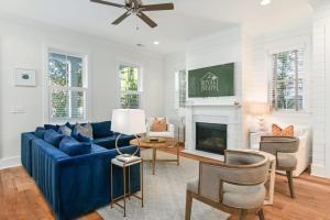 a living room with a blue couch and a fireplace at Shem Creek House- 5 Mins to Downtown & Beach in Charleston