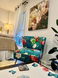 a living room with a chair and a painting at Eleni’s Charming Studio in North Beach