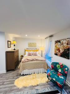 a bedroom with a large bed and a chair at Eleni’s Charming Studio in North Beach