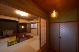 a room with a table and a room with a door at Kamekawa Yukari Ann in Beppu
