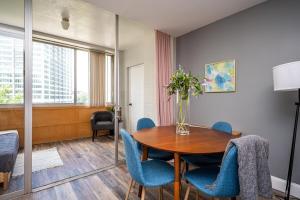 a dining room with a table and blue chairs at Atlanta Downtown! High Rise! Onsite Parking LM609 in Atlanta