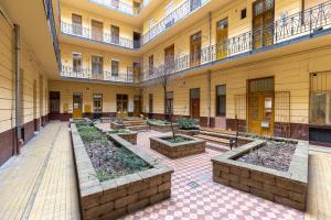 a building with a row of plants in a courtyard at Harmony & Cute - central apartments in Budapest