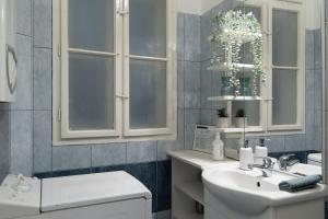 a white bathroom with a sink and a toilet at Harmony & Cute - central apartments in Budapest +34 photos