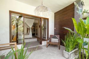 a room with a bedroom with a mirror and some plants at Village Bali in Uluwatu