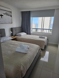 a hotel room with two beds and a large window at Centrepoint Resort in Gold Coast +42 photos