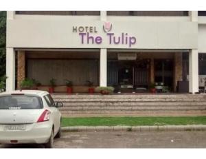 a white car parked in front of a hotel the tulip at Hotel The Tulip ,Chandigarh in Chandīgarh