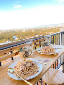 two plates of food on a table on a balcony at Sea & City lights View in Lapu Lapu City