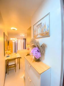 a kitchen with a counter with a vase of flowers on it at Sea & City lights View in Lapu Lapu City