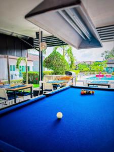 a pool table in front of a swimming pool at Billabong Golf Club & Resort in Nong Prue