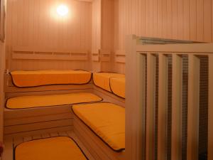 a small room with three bunk beds in it at OMO5 Hakodate by Hoshino Resorts in Hakodate