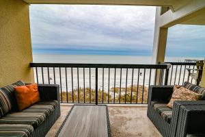 a balcony with two couches and a view of the ocean at Direct Oceanfront Magic at Sea Marsh w Pool in Myrtle Beach