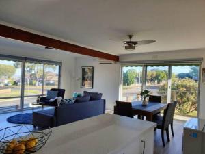 a living room with a couch and a table at Geelong Delight: Embrace Comfort @ Braund Avenue in Norlane