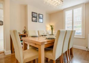 a dining room with a wooden table and chairs at Salisbury House in Southwold