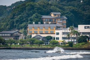 a large building on the shore of a body of water at 湘南江の島　御料理旅館　恵比寿屋 in Fujisawa