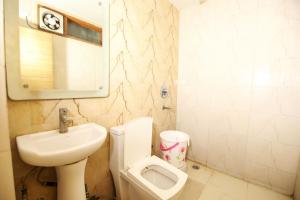 łazienka z toaletą, umywalką i pisuarem w obiekcie Hotel Lav-Kush w Nowym Delhi