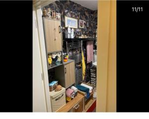 a room with a kitchen with cabinets and a room with a room at Room in zone 2 in London