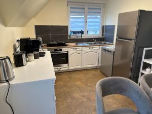 a kitchen with a stainless steel refrigerator and a counter at Appartement Algo in Algolsheim