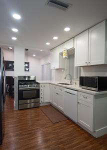 a kitchen with white cabinets and stainless steel appliances at Sunrise 3 bed @ sawgrass mills in Sunrise