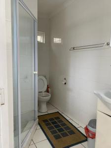 a bathroom with a shower and a toilet and a sink at MakiSaki Beach House in Herolds Bay