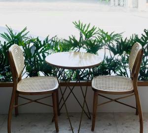 two chairs and a table and a table and two chairs at HOLIDAY HOTEL PHAN THiẾT in Ấp Bình Hưng