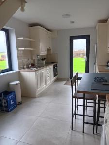 a kitchen with a table and chairs in a room at Duplex/2 Bedrooms on Kildare/Carlow/Laois Border in Carlow