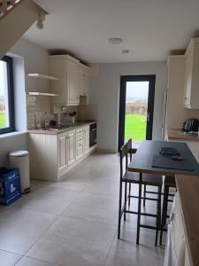 a kitchen with a table and chairs in a room at Duplex/2 Bedrooms on Kildare/Carlow/Laois Border in Carlow