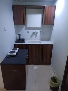 a small kitchen with a sink and a counter at شقق الملتقي in Al Nairyah