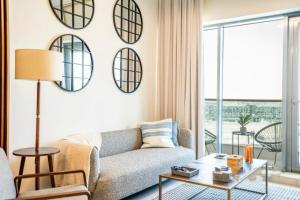 a living room with a couch and mirrors on the wall at Furnished 1 bhk in business bay in Dubai