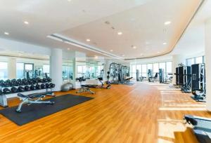 a gym with treadmills and exercise equipment in a room at Furnished 1 bhk in business bay in Dubai