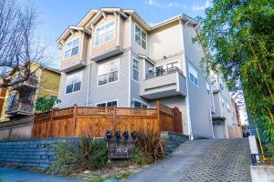 a large white house with a wooden fence at Ballard's Townhome with office & walk score 98 in Seattle