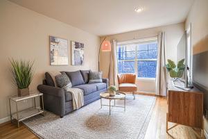 a living room with a couch and a window at Ballard's Townhome with office & walk score 98 in Seattle