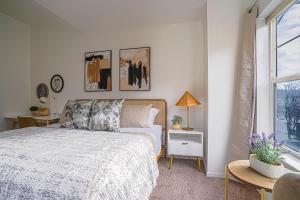 a white bedroom with a bed and a window at Ballard's Townhome with office & walk score 98 in Seattle