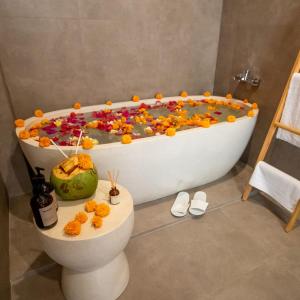 a bath tub full of candy in a bathroom at Brand New Villa - BEST Location Near City Center and Beach! in Kerobokan
