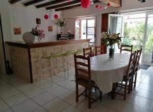 een keuken en eetkamer met een tafel en stoelen bij CHARMANT LOGEMENT ENTIER A LA CAMPAGNE in Sencenac-Puy-de-Fourches