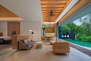 a villa with a pool and a living room at Four Points by Sheraton Bintan, Lagoi Bay in Lagoi