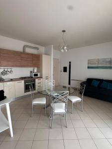 a kitchen and living room with a table and chairs at Morning for you in Bologna