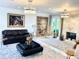 a living room with a couch and a fireplace at Luxury White Beach House in Redondo Beach