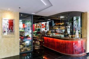 a bar in a restaurant with a red counter at Tracy Ben Thanh Tower in Ho Chi Minh City