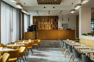 a row of tables and chairs in a restaurant at Be One Hotel in Sofia