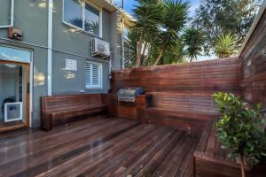 a wooden deck with a grill on a house at Sherbourne Retreat in Newtown in Geelong